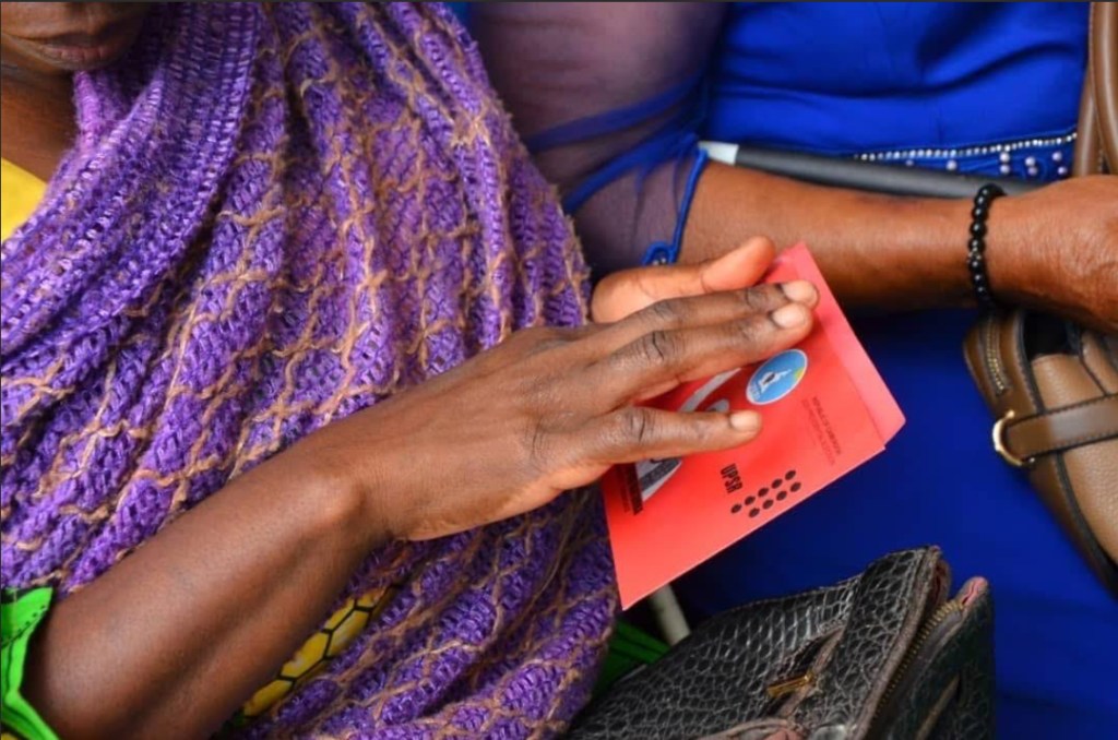 (Photo via ELECAM: visually impaired with braille ballot)