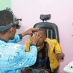A child receiving free eye screening from MICEI Staff