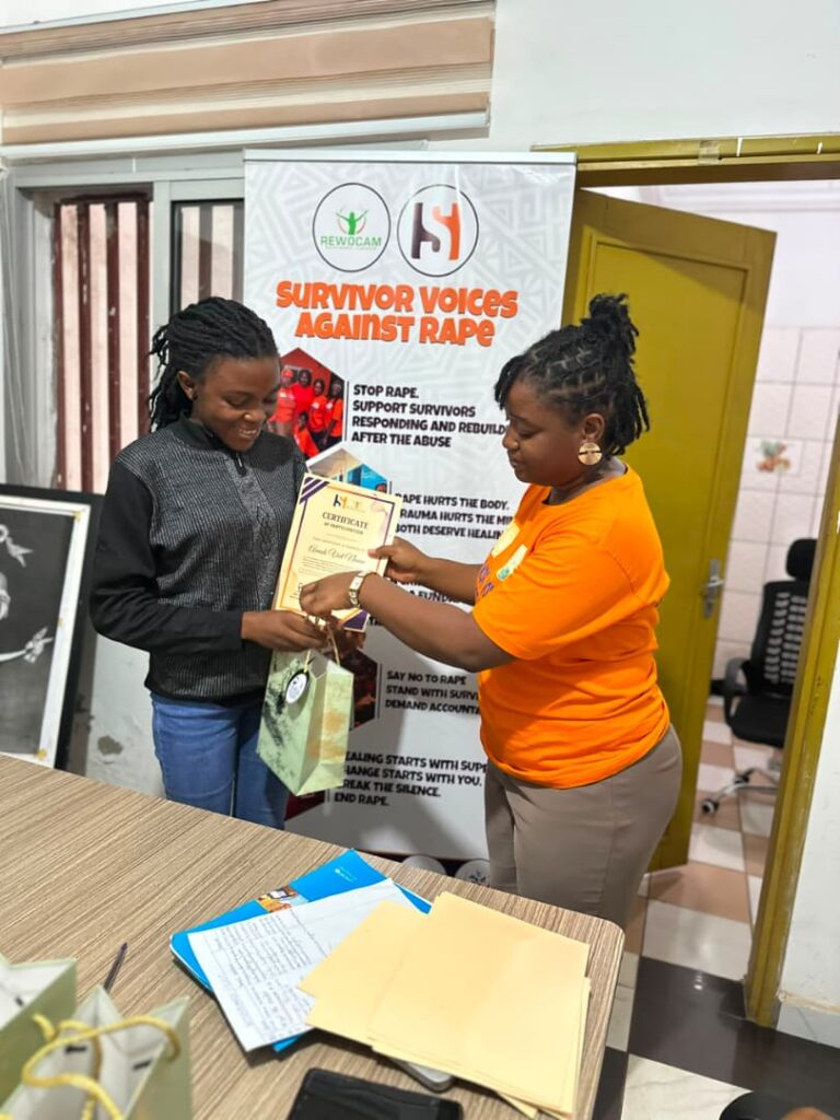 Safe Haven Foundation Founder, Dinayen Emilien, handing over a certificate to participant